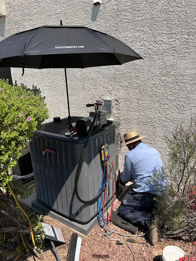 HVAC technician performing outdoor AC maintenance in Roanoke